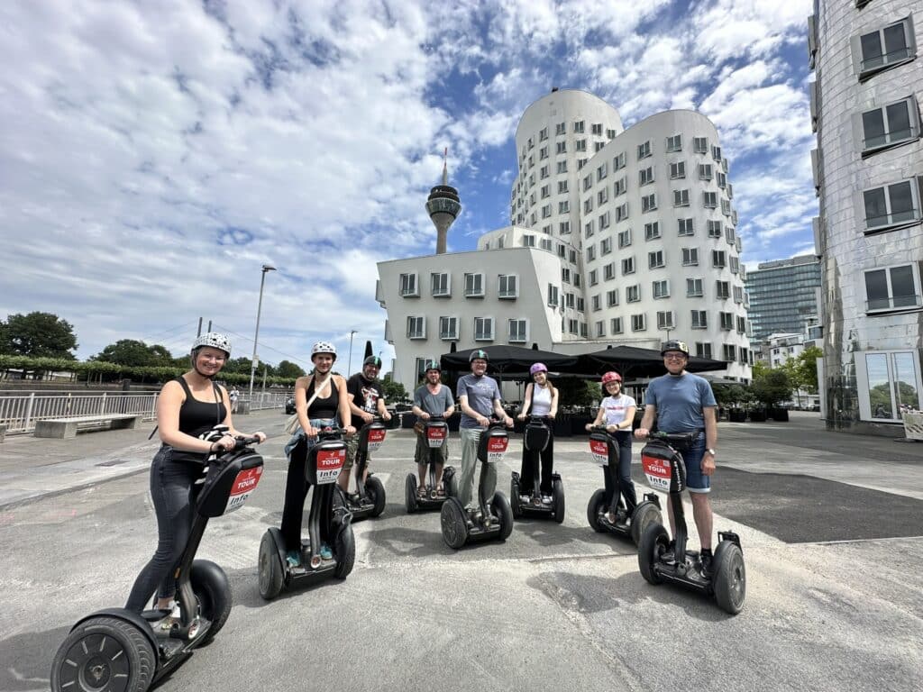 Segway-Tour in Düsseldorf entlang der Rheinpromenade mit Blick auf Rheinturm und Skyline